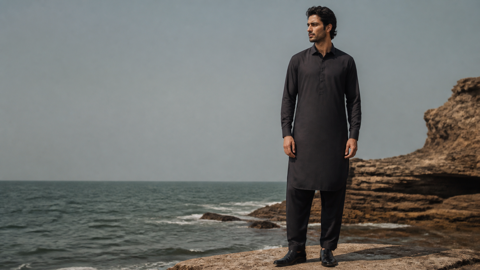 Male model wearing a charcoal shalwar qameez